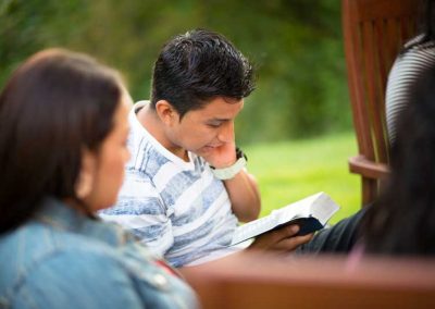 A man studying the scriptures outdoors.